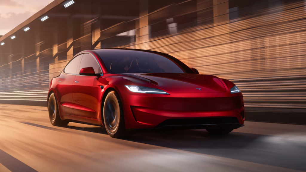 Photo of a red 2024 Tesla Model 3 Performance driving fast along the home stretch of a race track (source: https://www.tesla.com/model3-performance).